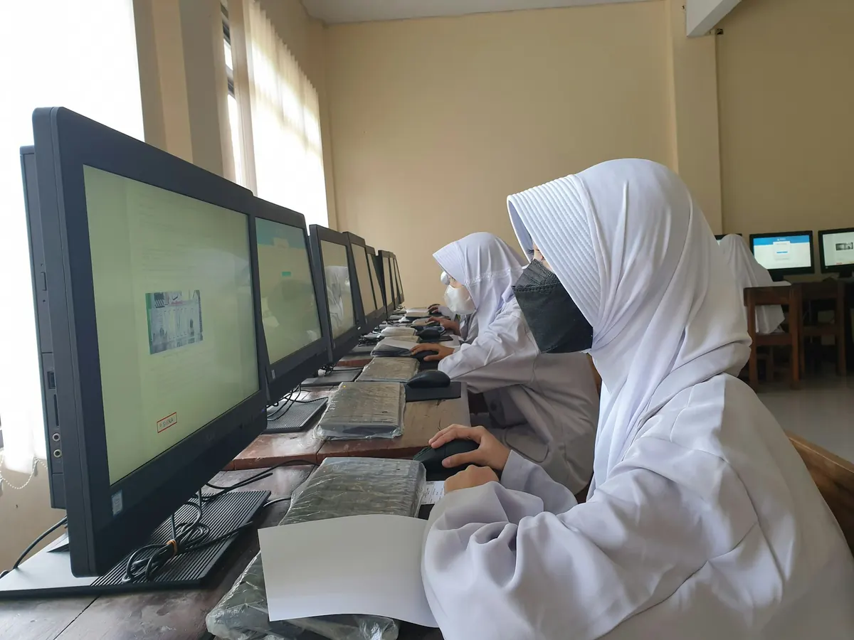 Students working at computers in the D-TECH training lab